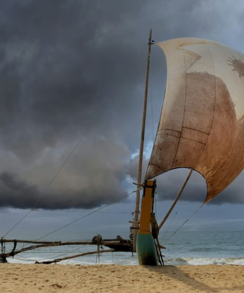 Fishing boats resting on empty beach in Sri Lanka